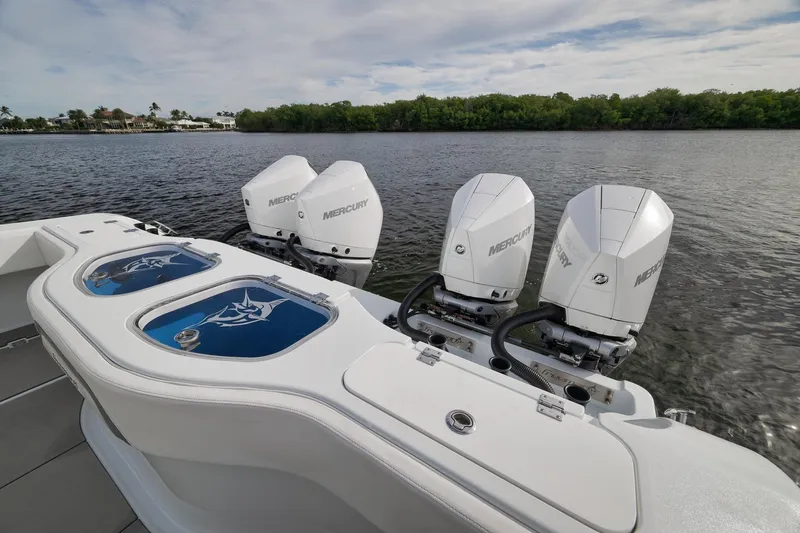 Slide: The Image of Freeman 42LR 2022 boat with four Mercury outboard engines on a calm lake. - 32