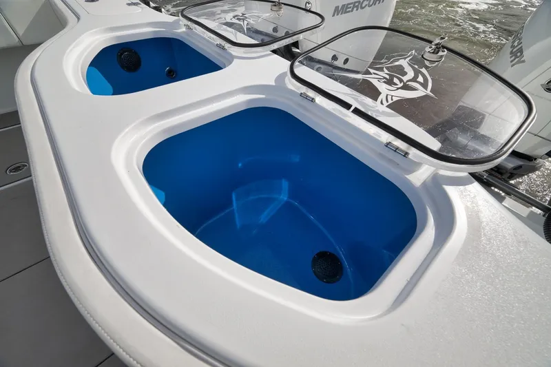 Slide: The Image of Livewell compartments on a 2022 Freeman 42LR boat, featuring blue interiors and clear lids. - 35