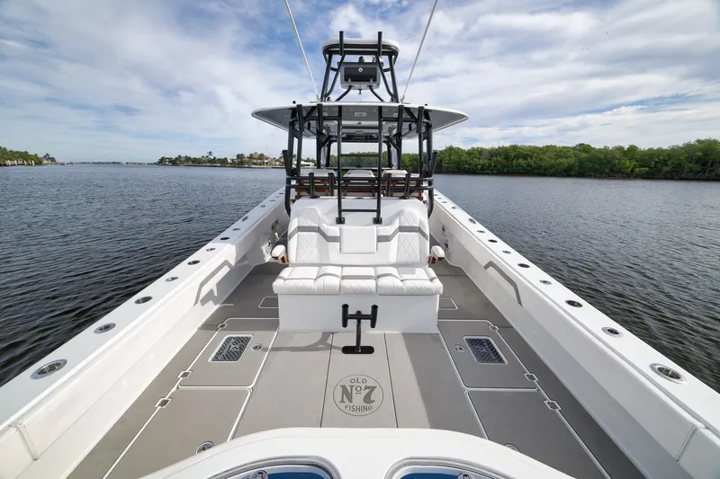 Slide: The Image of 2022 Freeman 42LR boat on calm water, featuring spacious deck and seating. - 38