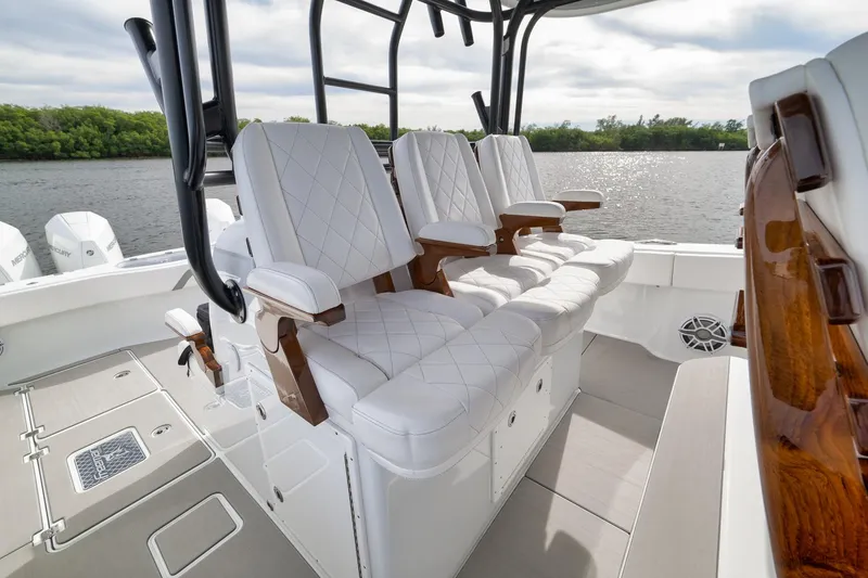 Slide: The Image of Luxurious seating on 2022 Freeman 42LR boat, featuring elegant white upholstery and wooden accents. - 44