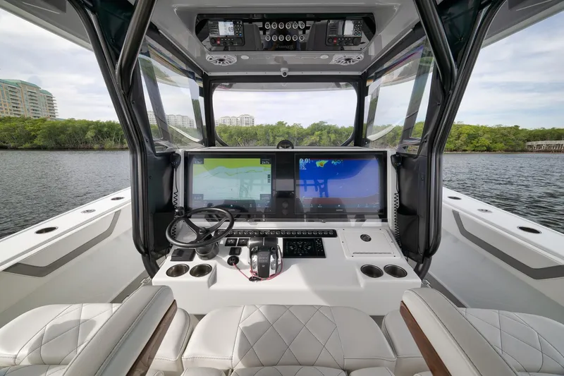 Slide: The Image of Cockpit of 2022 Freeman 42LR boat with advanced navigation displays and luxurious seating. - 48
