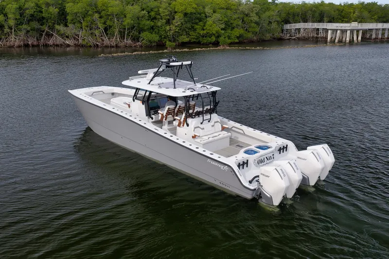 Slide: The Image of 2022 Freeman 42LR boat with triple Mercury engines on calm water. - 5