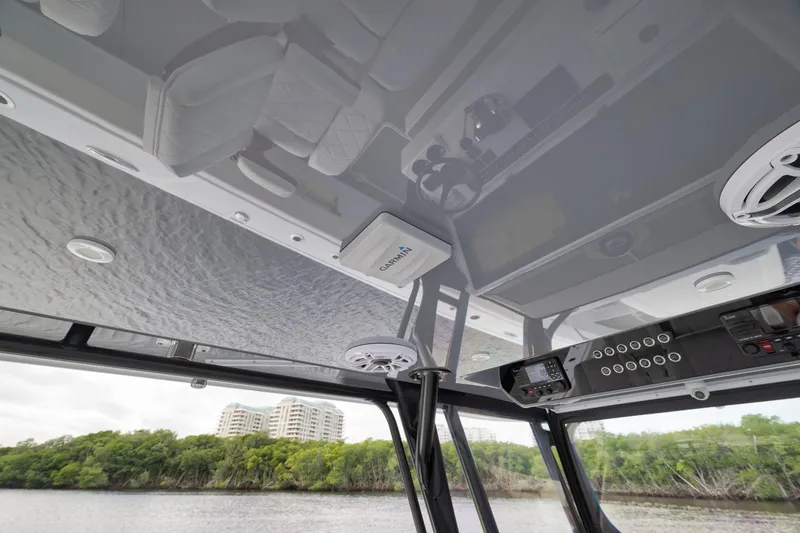 Slide: The Image of Interior view of 2022 Freeman 42LR boat with modern controls and scenic background. - 51