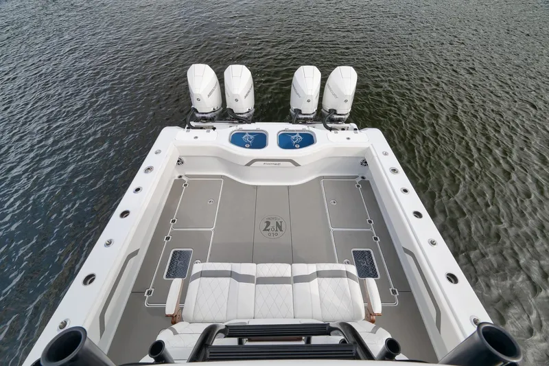 Slide: The Image of 2022 Freeman 42LR boat with four engines on calm water. - 58