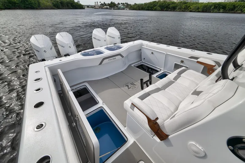 Slide: The Image of 2022 Freeman 42LR boat interior with Mercury engines, featuring luxurious seating and storage compartments. - 59