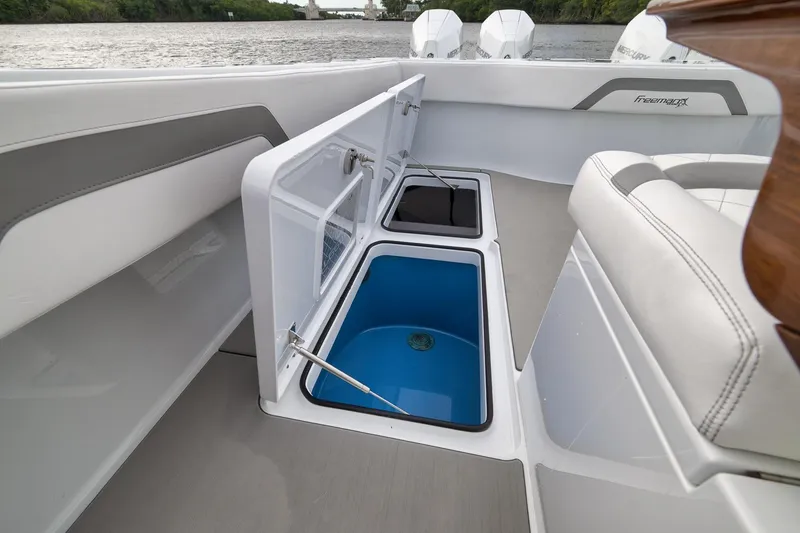 Slide: The Image of 2022 Freeman 42LR boat interior with open storage compartments and seating. - 60
