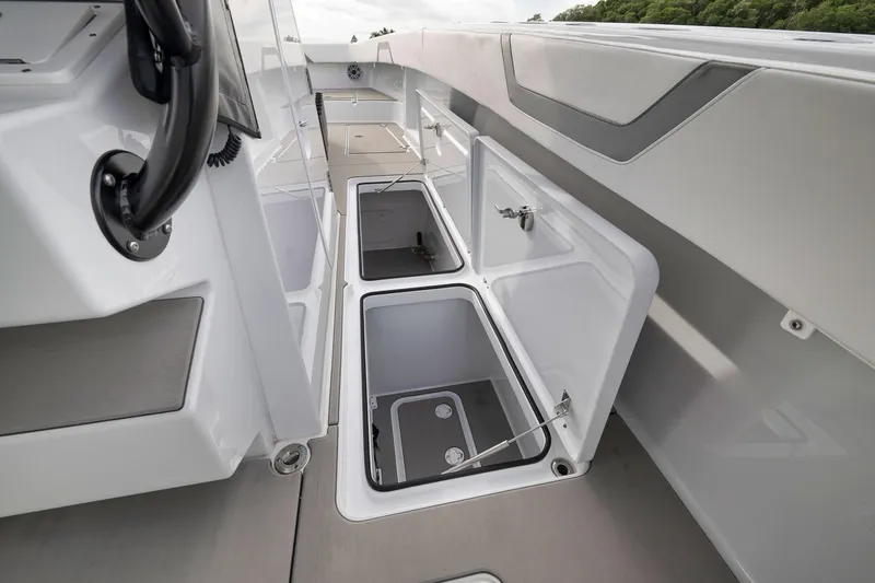 Slide: The Image of 2022 Freeman 42LR boat interior with open storage compartments, showcasing sleek design. - 66