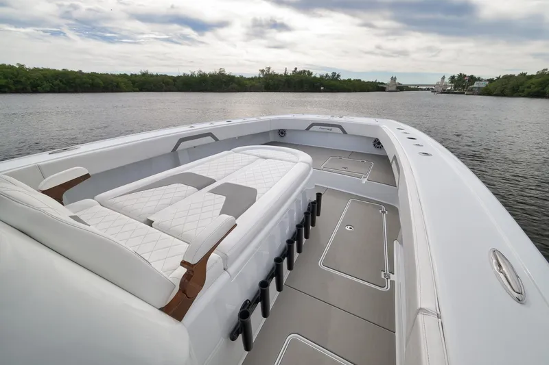 Slide: The Image of Luxurious 2022 Freeman 42LR boat interior with elegant seating on a serene waterway. - 69