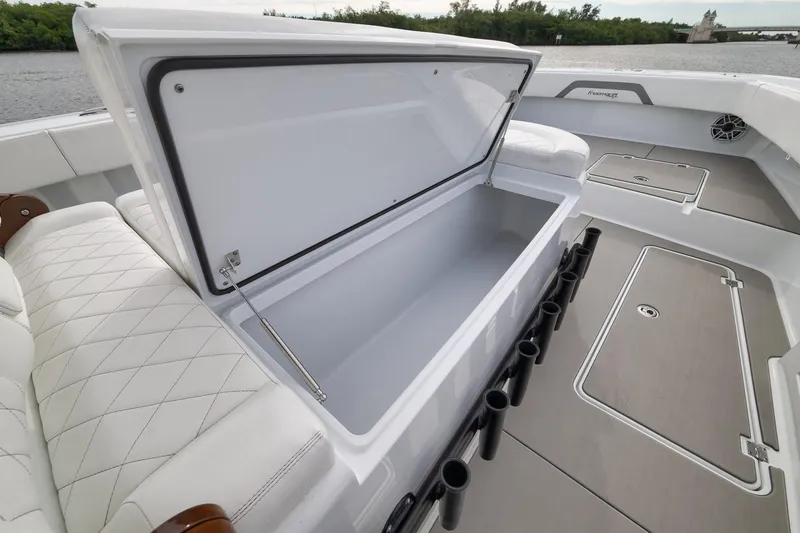 Slide: The Image of Freeman 42LR 2022 boat interior with open storage compartment and rod holders. - 71