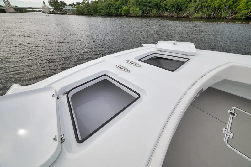 Slide: The Image of Bow of 2022 Freeman 42LR boat with open hatches on calm water. - 75