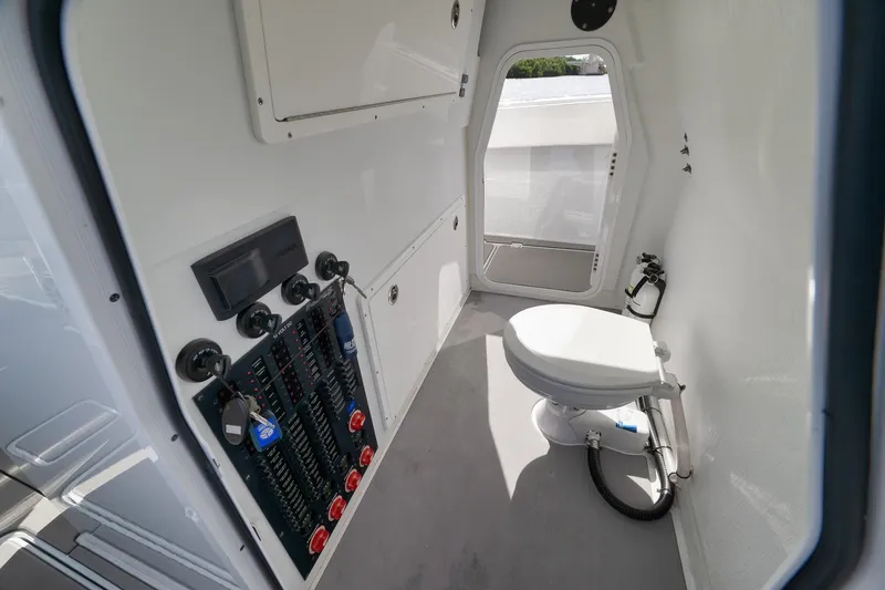 Slide: The Image of Interior of a 2022 Freeman 42LR boat featuring a compact bathroom with control panel. - 76