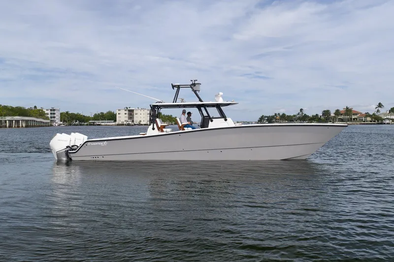 Slide: The Image of 2022 Freeman 42LR boat cruising on calm waters under a clear sky. - 8