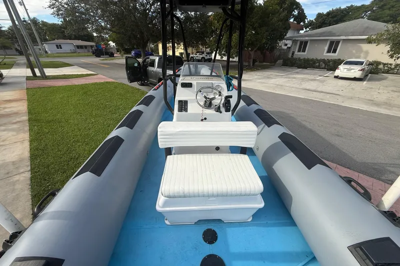 Slide: The Image of 1998 Novamarine SEVEN HD inflatable boat with steering console, parked in residential area. - 10