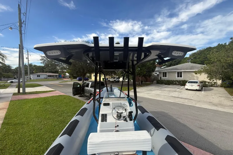 Slide: The Image of Novamarine SEVEN HD 1998 boat on trailer in suburban neighborhood, under clear sky. - 11