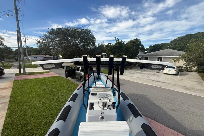 Slide: The Image of 1998 Novamarine SEVEN HD boat parked in residential driveway under clear blue sky. - 13
