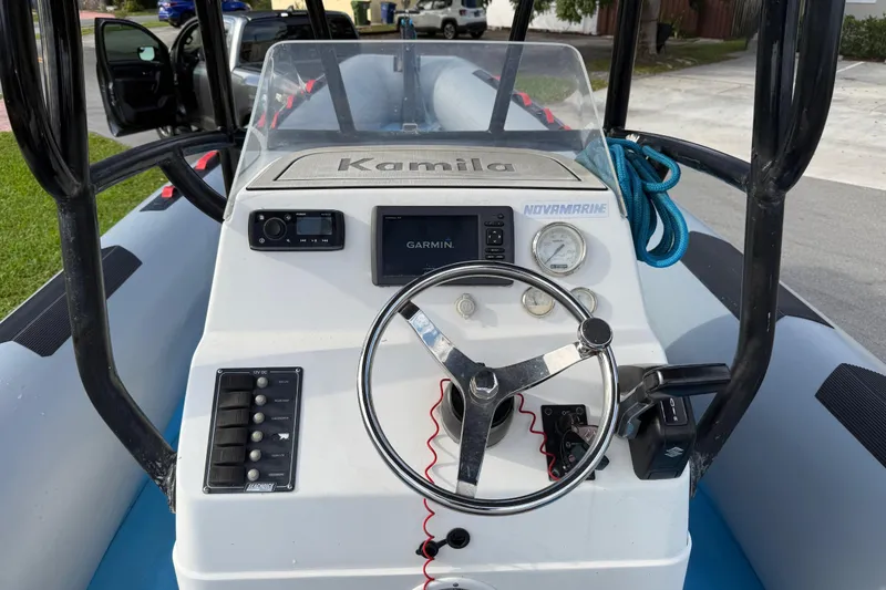 Slide: The Image of Control panel of a 1998 Novamarine SEVEN HD boat with steering wheel and navigation equipment. - 15