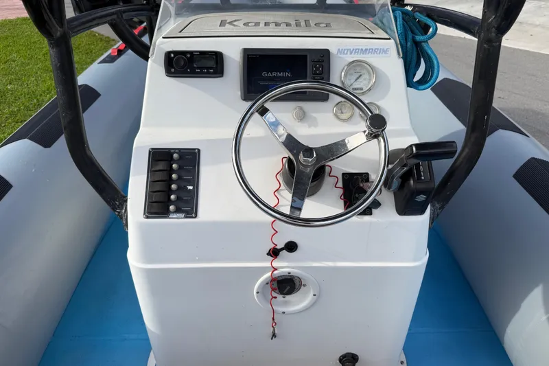 Slide: The Image of Control panel of a 1998 Novamarine SEVEN HD boat with steering wheel and navigation equipment. - 16