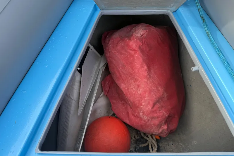 Slide: The Image of Storage compartment of 1998 Novamarine SEVEN HD with red bag and orange buoy. - 18