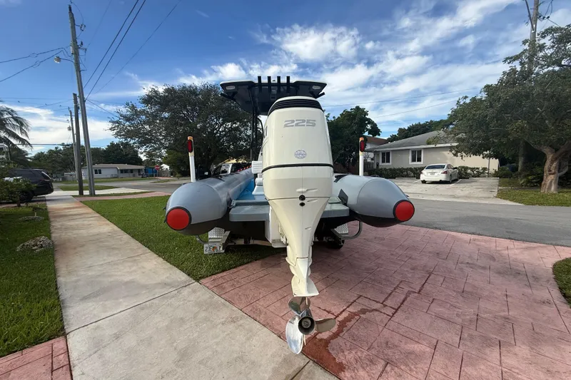 Slide: The Image of 1998 Novamarine SEVEN HD boat with outboard motor on driveway under blue sky. - 21