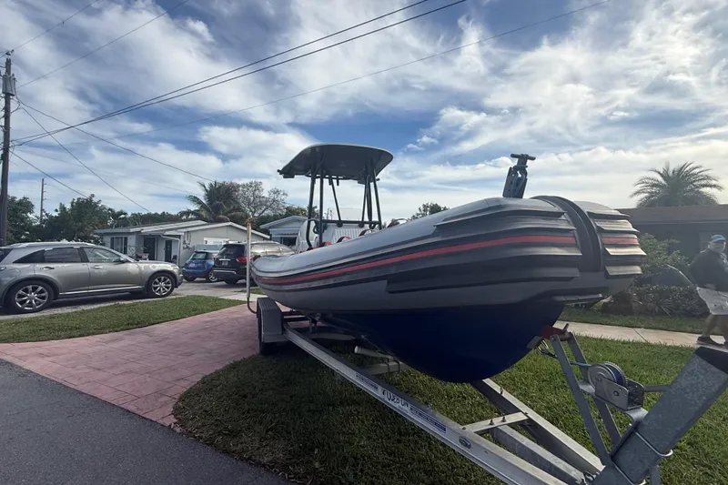 Slide: The Image of Novamarine SEVEN HD 1998 boat on trailer in residential driveway, under a partly cloudy sky. - 3