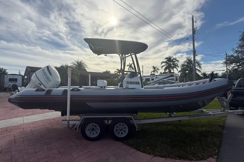 Slide: The Image of 1998 Novamarine SEVEN HD boat on trailer, parked outdoors under cloudy sky. - 4