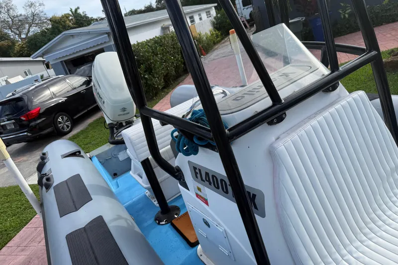 Slide: The Image of Novamarine SEVEN HD 1998 boat with outboard motor, parked in a residential driveway. - 9