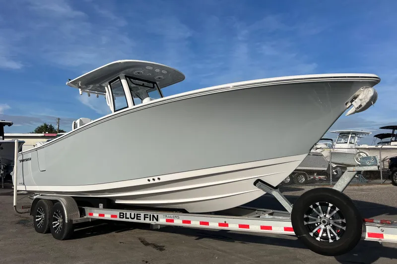Slide: The Image of 2026 Sportsman Heritage 261 Center Console boat on trailer under blue sky. - 0