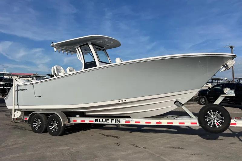 Slide: The Image of 2026 Sportsman Heritage 261 Center Console boat on trailer under blue sky. - 1