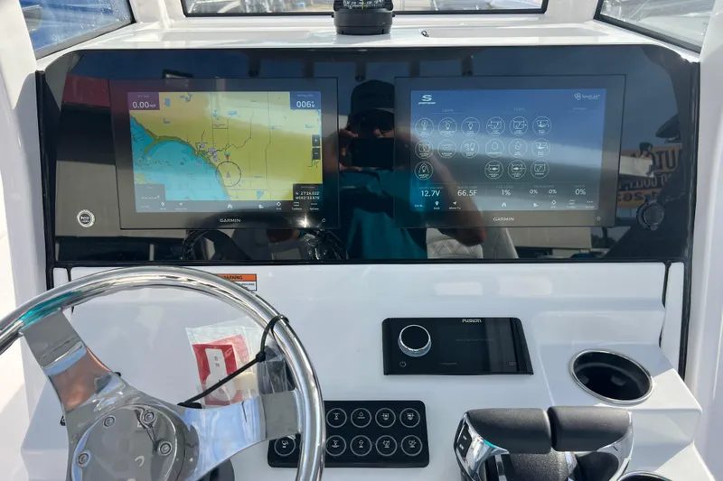 Slide: The Image of 2026 Sportsman Heritage 261 Center Console dashboard with dual Garmin displays and steering wheel. - 13