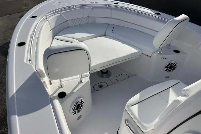 Slide: The Image of 2026 Sportsman Heritage 261 Center Console boat interior with white seating and table. - 14