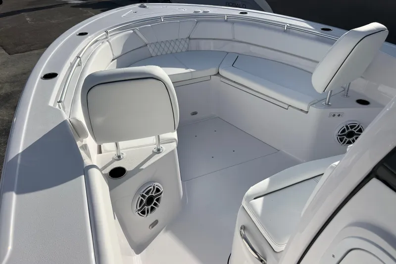Slide: The Image of 2026 Sportsman Heritage 261 Center Console boat interior with white seating and speakers. - 16