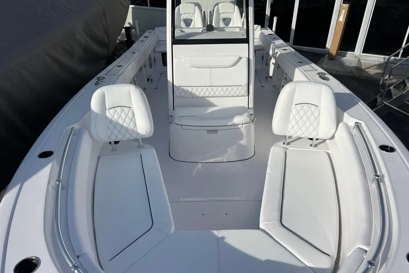 Slide: The Image of 2026 Sportsman Heritage 261 Center Console boat interior with white seating and console. - 19