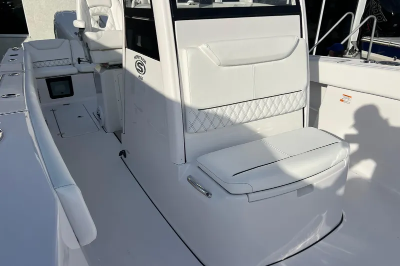 Slide: The Image of 2026 Sportsman Heritage 261 Center Console boat interior with white seating and console. - 20