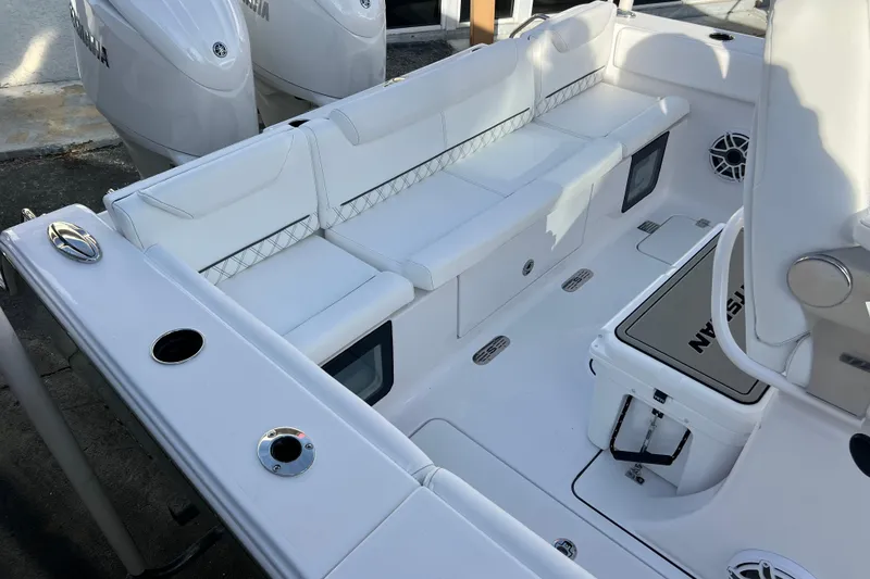 Slide: The Image of 2026 Sportsman Heritage 261 Center Console boat interior with white seating and storage. - 22