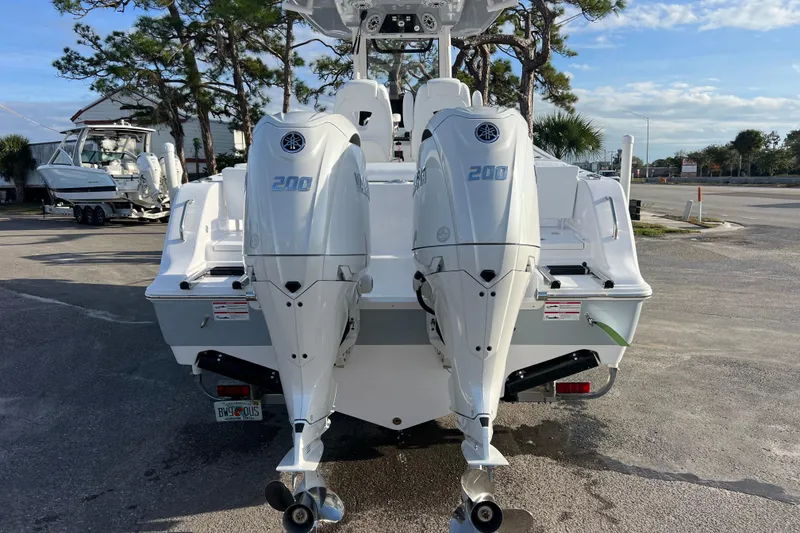 Slide: The Image of 2026 Sportsman Heritage 261 Center Console with dual Yamaha 200 engines, parked outdoors. - 5