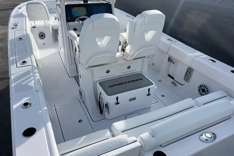 Slide: The Image of 2026 Sportsman Heritage 261 Center Console boat interior with white seating and modern controls. - 7