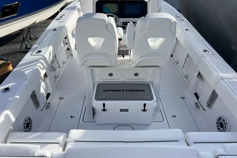 Slide: The Image of 2026 Sportsman Heritage 261 Center Console boat interior with white seating and Yeti cooler. - 8