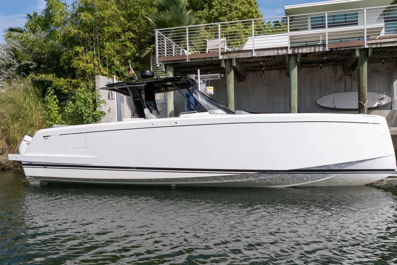 The Image of 2024 Pardo Yachts 38, sleek white design, docked near modern waterfront home. - 0