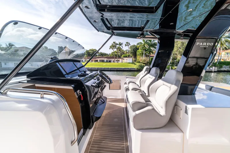 Slide: The Image of 2024 Pardo Yachts 38 docked in clear turquoise water, featuring multiple outboard engines. - 6