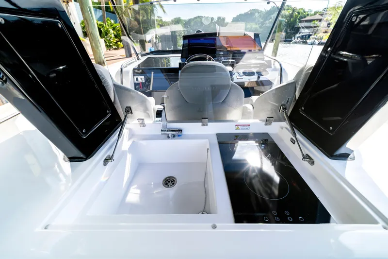 Slide: The Image of 2024 Pardo Yachts 38 with sleek design, docked by lush greenery and calm waters. - 11