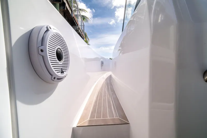 Slide: The Image of 2024 Pardo Yachts 38 with triple Racing 450 engines on a serene waterway. - 14