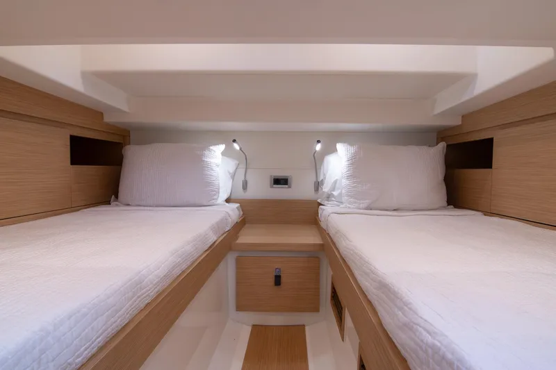 Slide: The Image of 2024 Pardo Yachts 38 interior with modern wooden stairs and cozy sleeping area. - 25