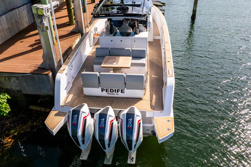 Slide: The Image of 2024 Pardo Yachts 38 docked, featuring triple outboard engines, spacious deck, and elegant design. - 3