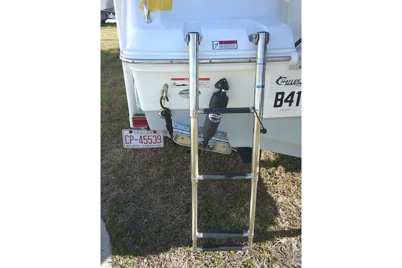 Slide: The Image of 2023 Sea Hunt Ultra 234 boat with ladder and North Carolina trailer plate. - 10