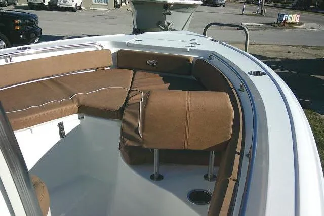 Slide: The Image of 2023 Sea Hunt Ultra 234 boat interior with brown cushioned seating. - 15
