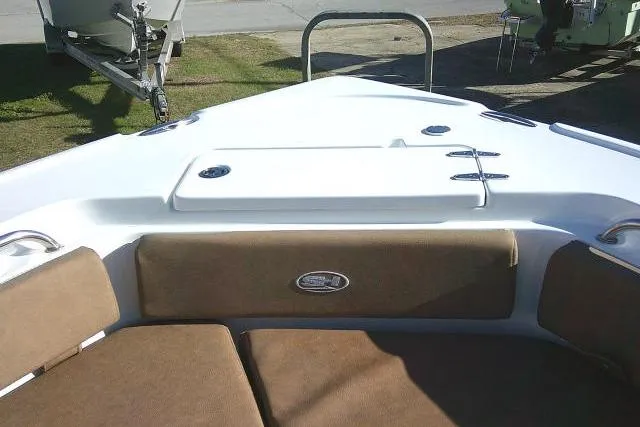 Slide: The Image of 2023 Sea Hunt Ultra 234 boat interior with cushioned seating and storage area. - 16