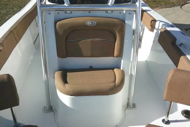 Slide: The Image of 2023 Sea Hunt Ultra 234 boat interior with brown cushioned seating. - 18