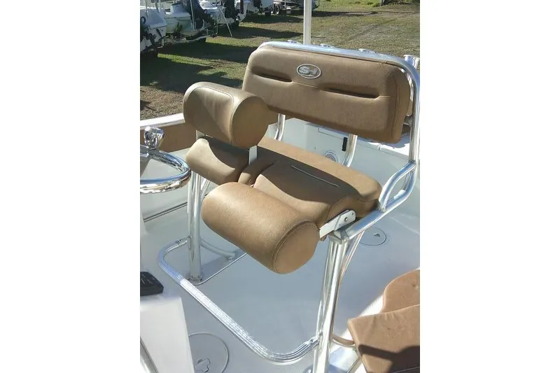 Slide: The Image of 2023 Sea Hunt Ultra 234 boat seat with brown cushioned upholstery and chrome frame. - 21