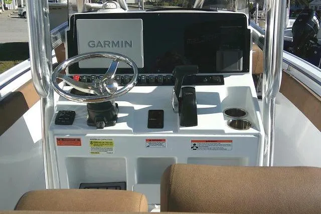 Slide: The Image of 2023 Sea Hunt Ultra 234 boat console with Garmin navigation system and steering wheel. - 25