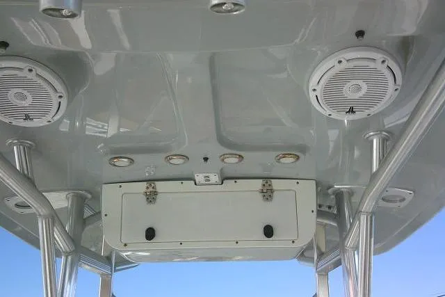 Slide: The Image of 2023 Sea Hunt Ultra 234 boat interior ceiling with speakers and storage compartment. - 26